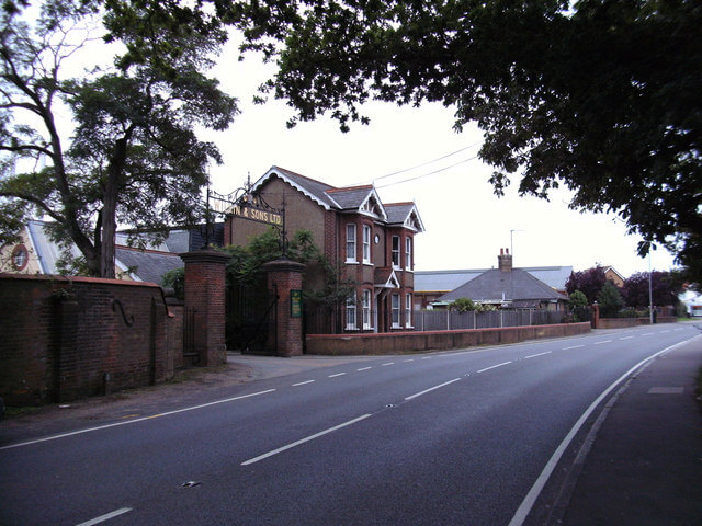 The Wilkin & Sons Ltd factory gates in Tiptree, with the company name in a wrought-iron arch over the entrance
